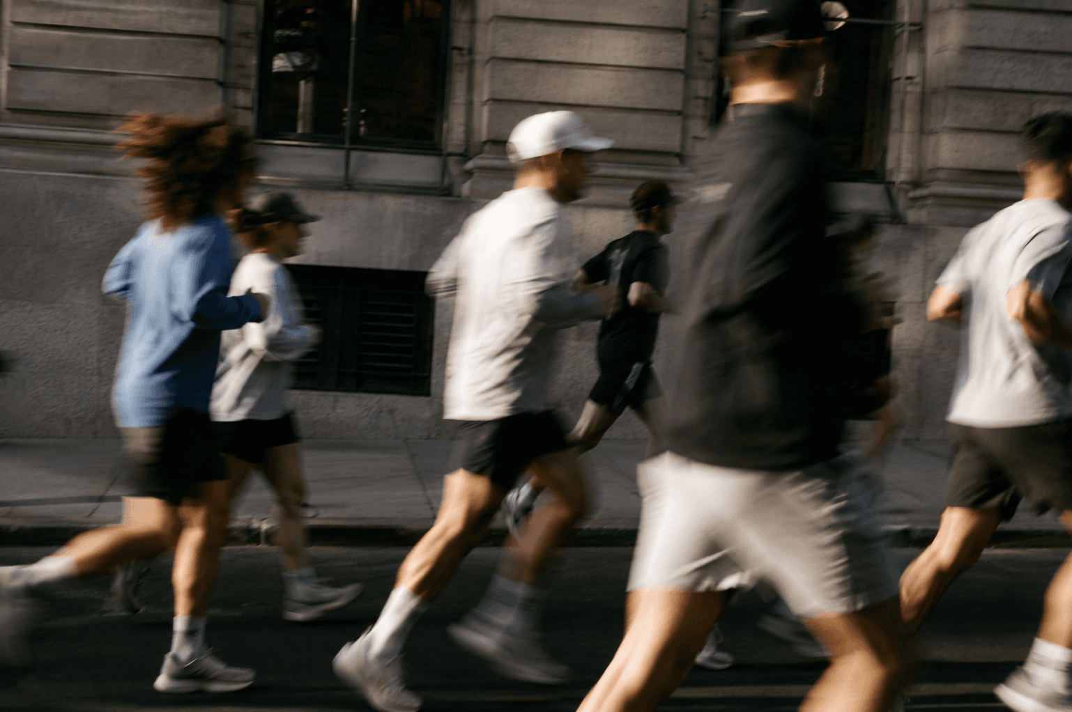 A group of runners passing in a blur of movement.