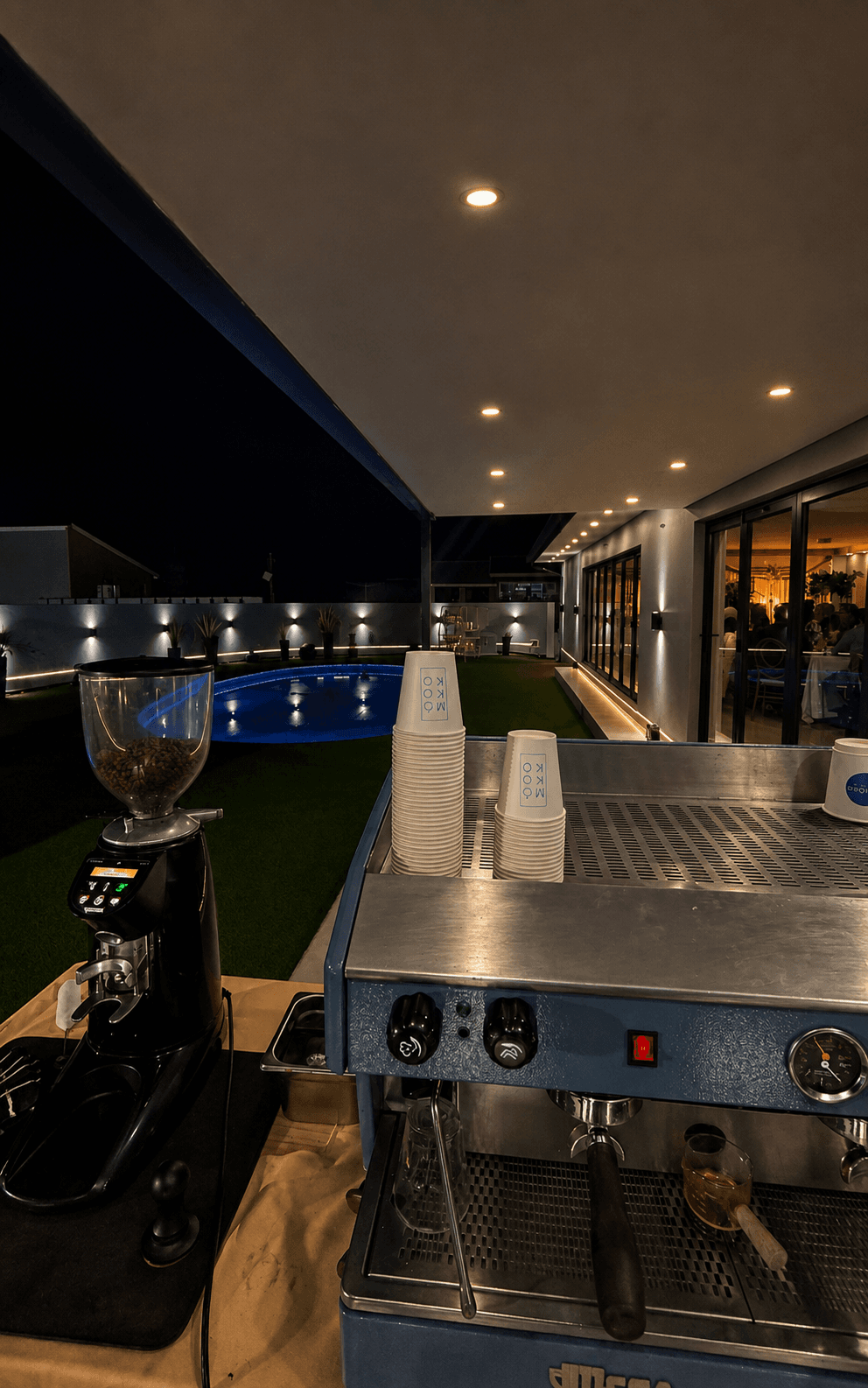 The MOKOKO machine set up overlooking a private pool at dusk.